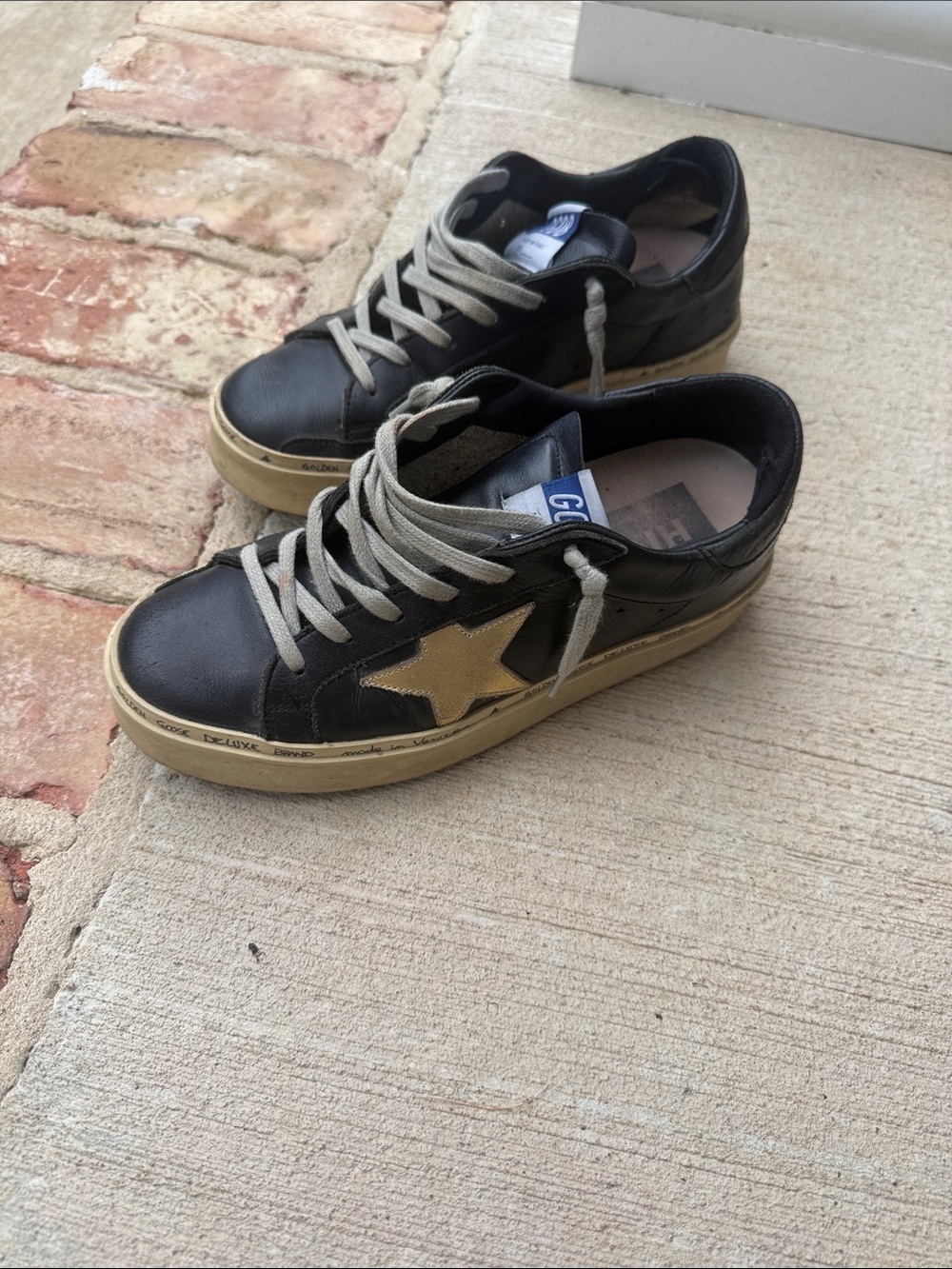 Women’s Golden Goose Black and Gold Hi Star Sneakers